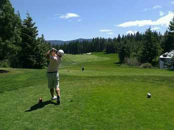 A golfer at address for a page on personalized golf club performance